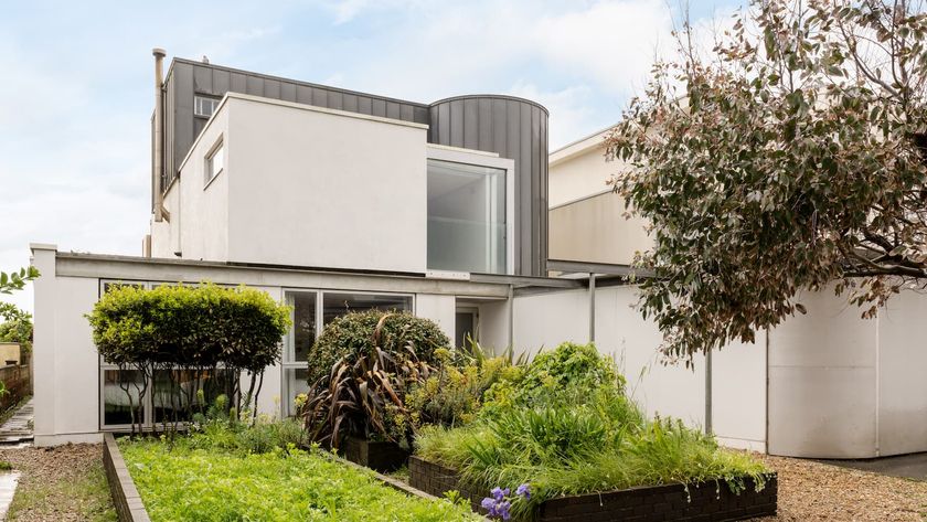 A white house with a raised garden bed 