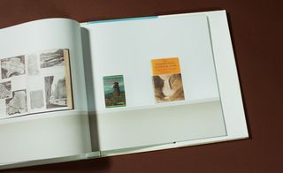 A close-up of a double page in the book with photos of two books.