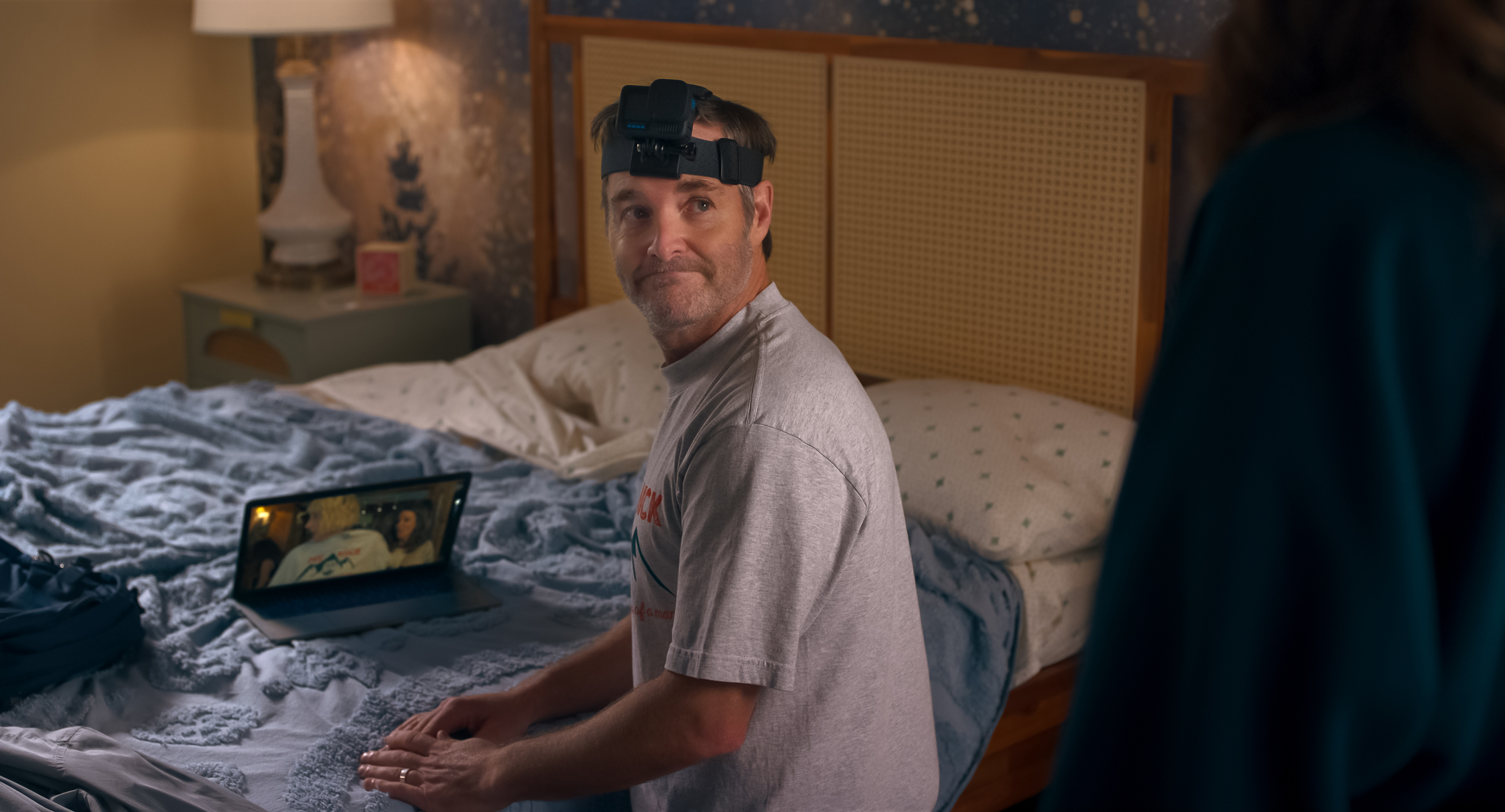 Will Forte as Jack wearing a flashlight helmet and watching something on a laptop in a bedroom in a still from the four seasons season 2