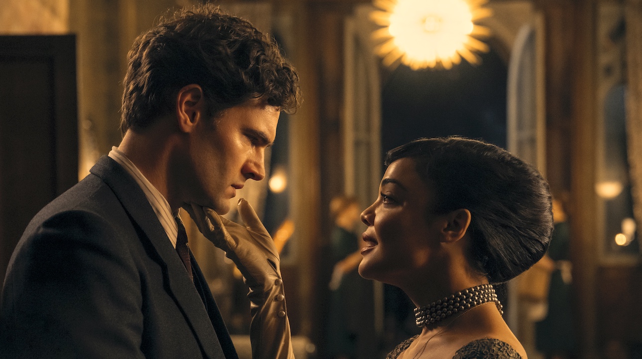 Tom Bateman and Tessa Thompson looking at each other in Hedda