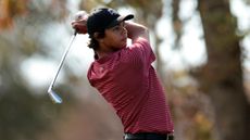 Charlie Woods plays an iron shot