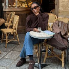 Influencer wears black loafers.