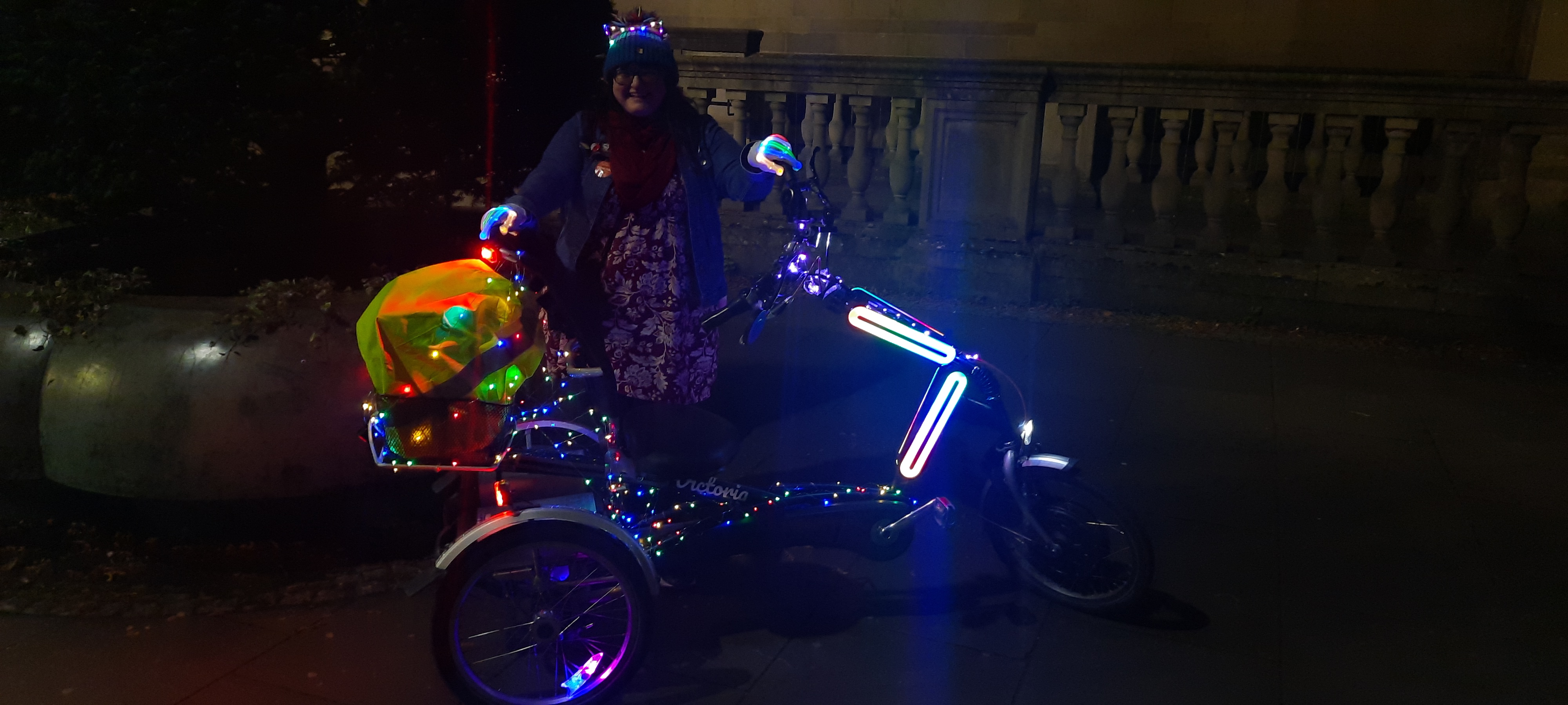 Person poses next to luminous adaptive bike
