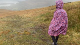 Julia Clarke hiking in a rain poncho