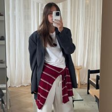 style influencers Johanna Lager poses for a mirror selfie wearing a chic spring 2026 outfit with standout basics like an oversize blazer and white T-shirt