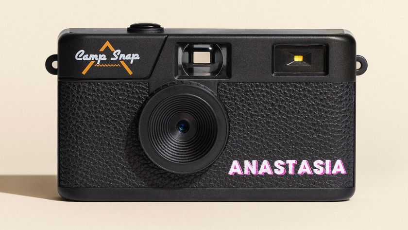Personalized Camp Snap camera with a name on it, with strong studio lighting and a cream colored backdrop