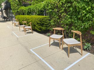 An outdoor waiting area at a restaurant in Illinois, with seats placed six feet apart.