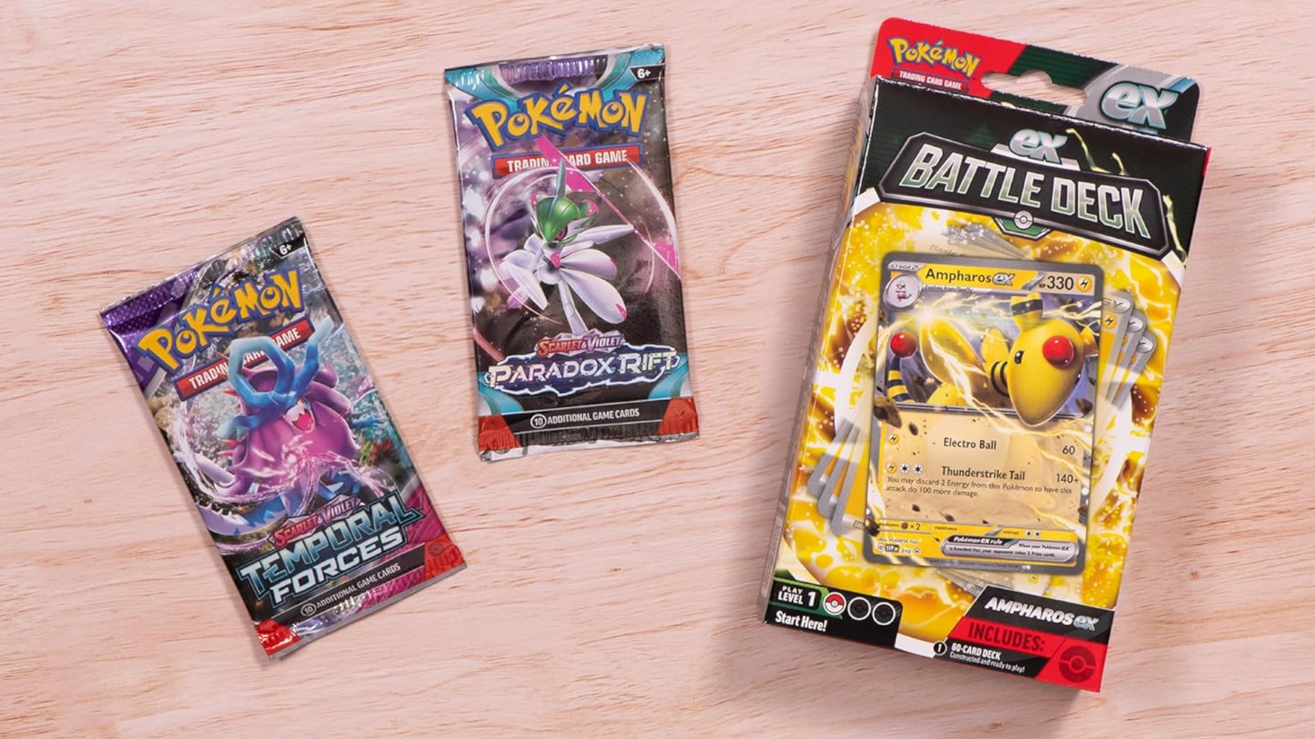 A Deck Box and Booster packs laid out on a wooden surface