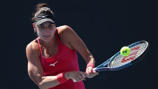 French tennis player Oceane Dodin, wearing a red top, returns the ball ahead of the Dodin vs Burel live stream at the 2024 Australian Open 