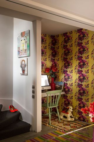 Small home office with pink and yellow wallpaper
