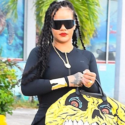 Rihanna was spotted in Barbados wearing a rare Longchamp Le Pliage bag and Fenty x Puma cleat flip-flops