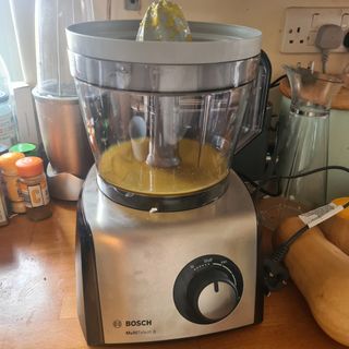 The Bosch MultiTalent 8 food processor with a juicing attachment covered in pulp.