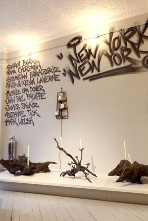 Graffiti artist Skott 'Rage' Johnson has emblazoned the names of the artists in the show on the walls in a street-style scrawl, above a series of candelabras by Michele Oka Doner