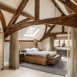 bedroom with wooden beams and curtains