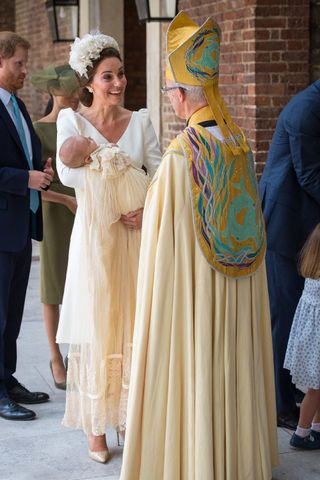 Britain's Catherine, Duchess of Cambridge holds Britain's Prince Louis of Cambridge as she speaks to Archbishop of Canterbury