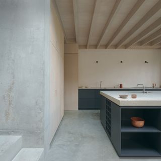 Concrete meets wood at extension at Concrete Plinth House by DGN studio