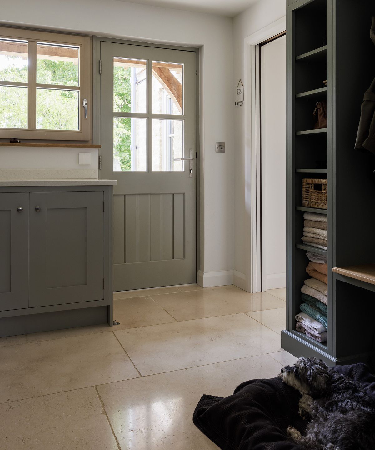 A hallway in a farmhouse style new build with buff tone flooring and neutral decor