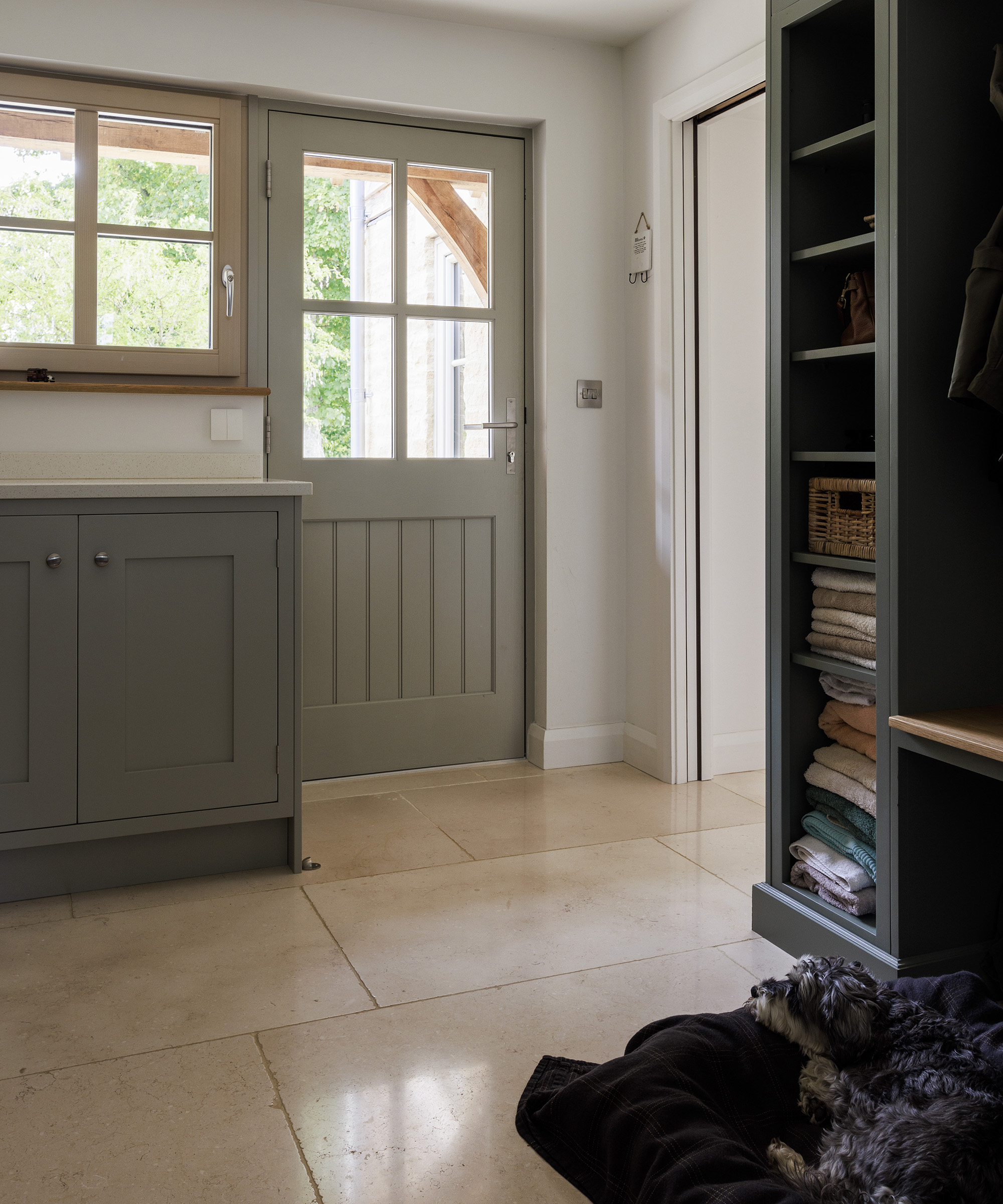 A hallway in a farmhouse style new build with buff tone flooring and neutral decor