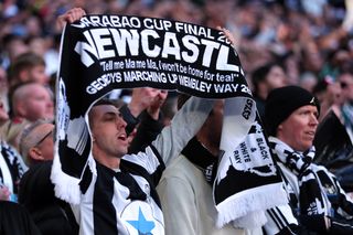 We Are Newcastle United episode 2: a fan holds a scarf at the Wembley cup final