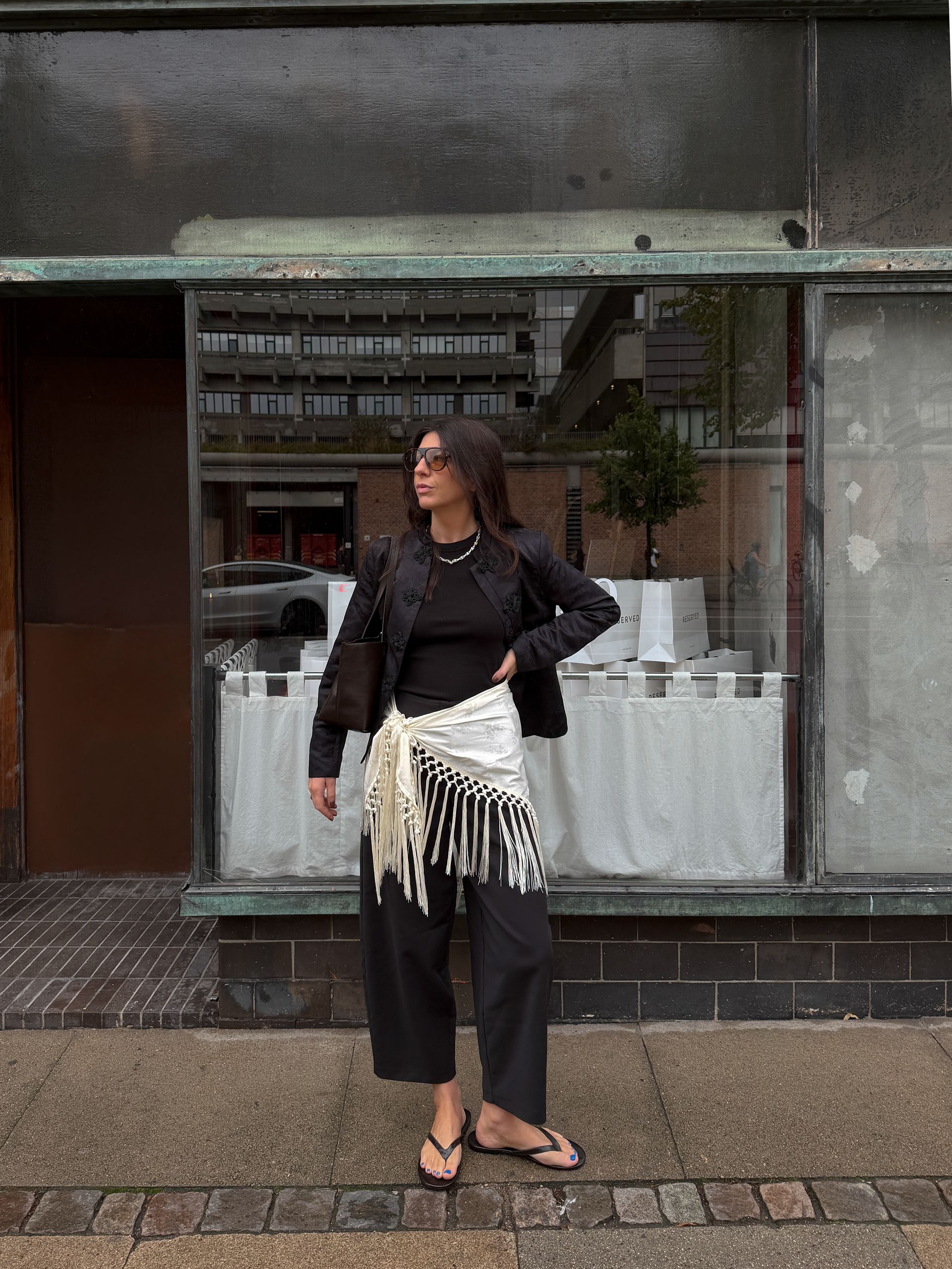 Layered sarong over black trousers.