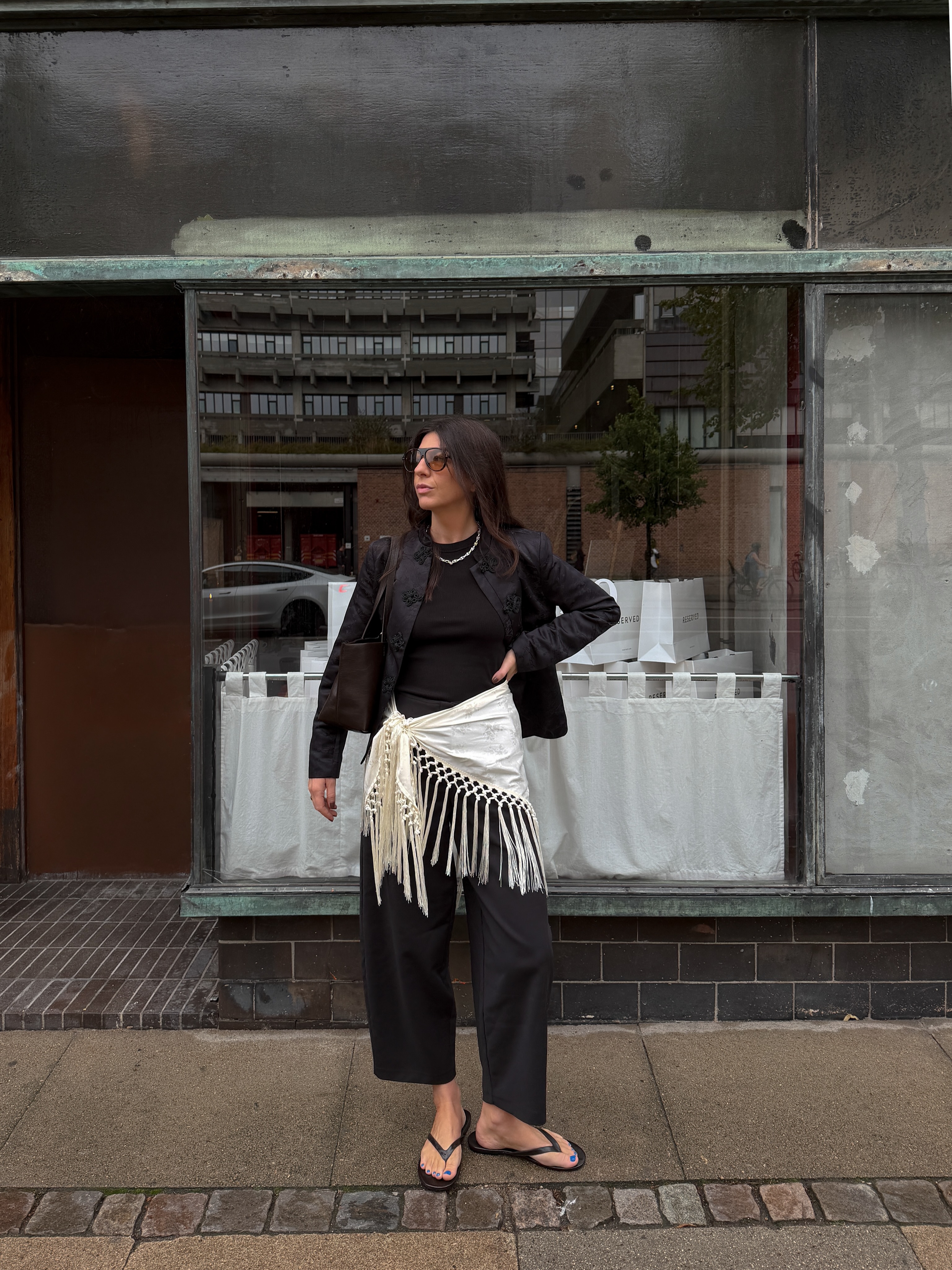 Layered sarong over black trousers.