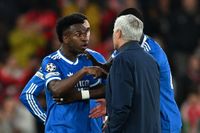 Vinicius Junior of Real Madrid speaks to Jose Mourinho, Head Coach of Benfica, after a clash with Gianluca Prestianni during the UEFA Champions League 2025/26 League Knockout Play-off First Leg match between SL Benfica and Real Madrid C.F. at Estadio do SL Benfica on February 17, 2026 in Lisbon, Portugal.
