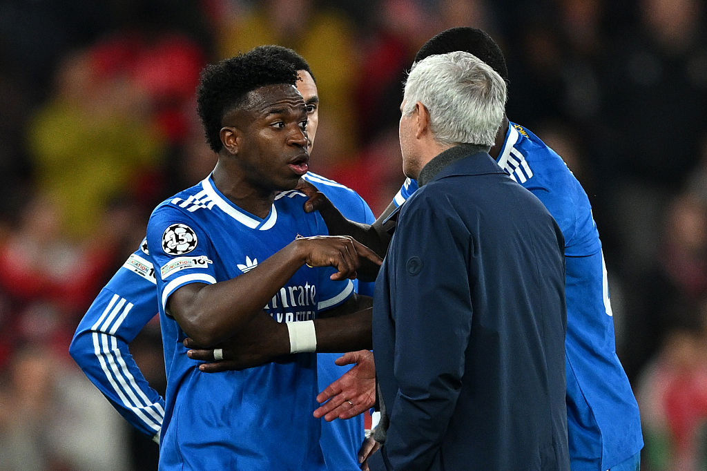 Vinicius Junior of Real Madrid speaks to Jose Mourinho, Head Coach of Benfica, after a clash with Gianluca Prestianni during the UEFA Champions League 2025/26 League Knockout Play-off First Leg match between SL Benfica and Real Madrid C.F. at Estadio do SL Benfica on February 17, 2026 in Lisbon, Portugal.