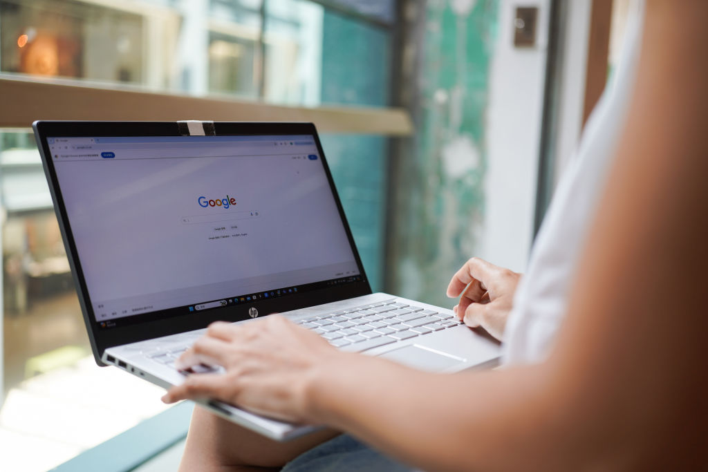 In this photo illustration, A woman browses the Google website on her laptop, which has the search engine technology