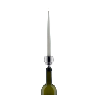 candle held in a chrome bottle stopper in a wine bottle