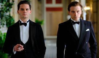 Jeremy Irvine and Jack Lowden walking down a hall in Benediction.