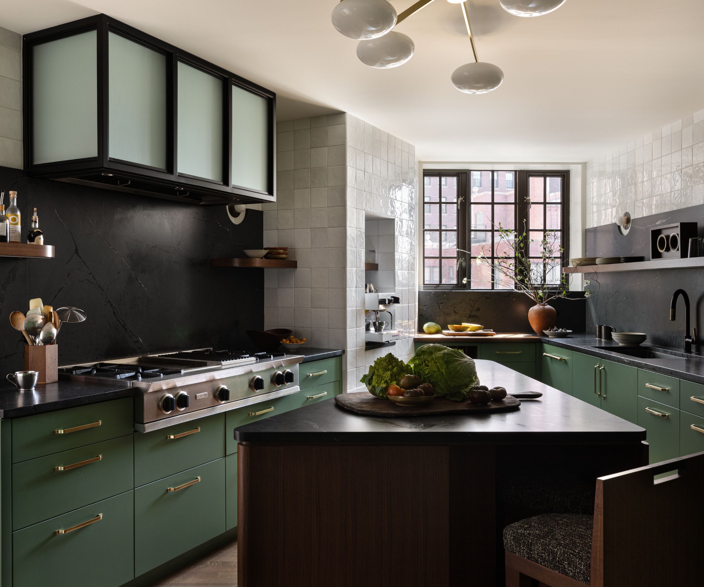modern kitchen with pistachio green cabinets, black accent wall and white tiled walls