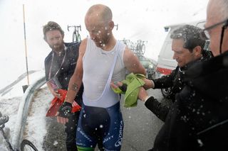 Svein Tuft stops to put on warm clothing on stage sixteen of the 2014 Giro d'Italia