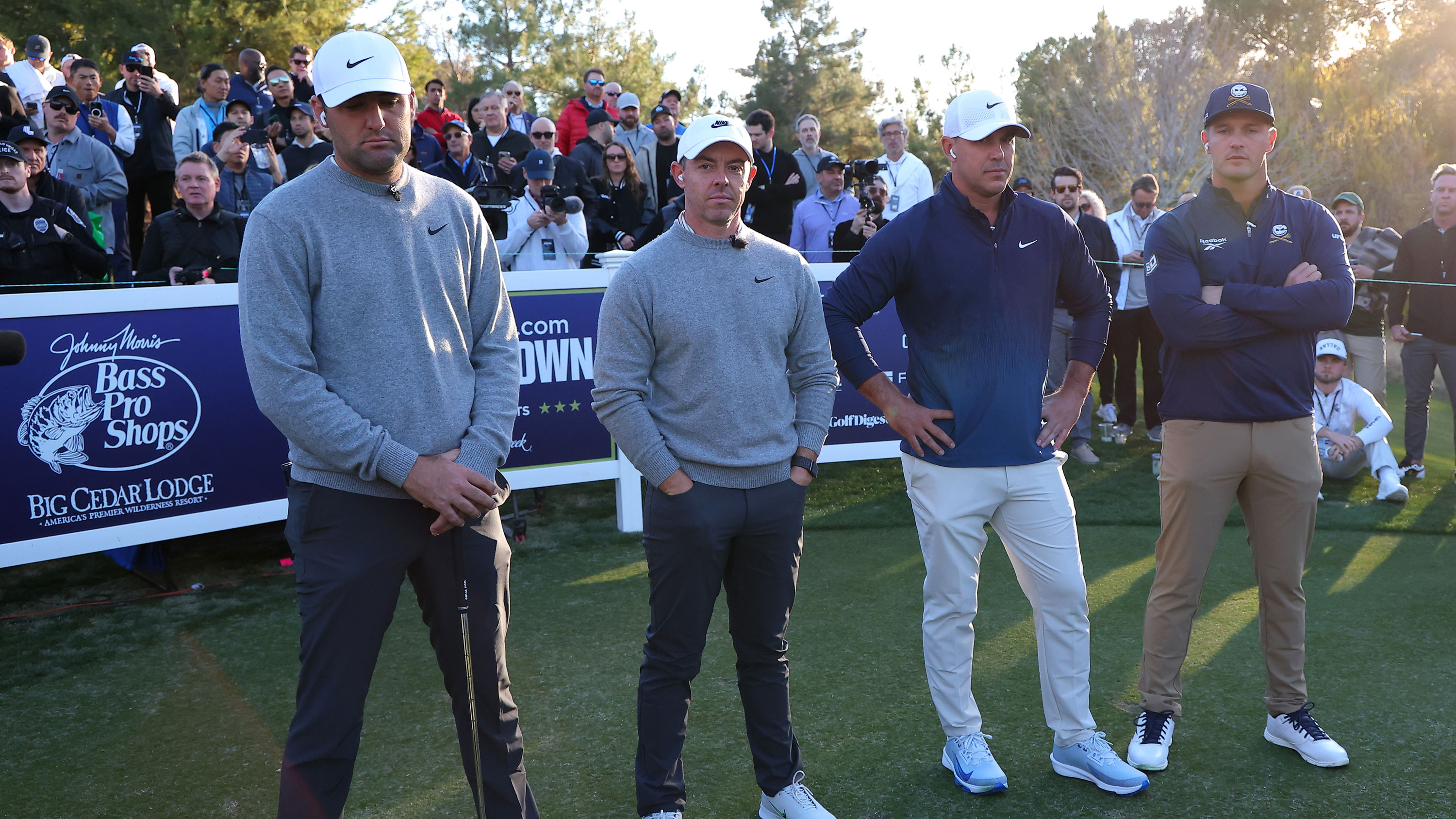 Scottie Scheffler, Rory McIlroy, Brooks Koepka and Bryson DeChambeau wait at The Showdown