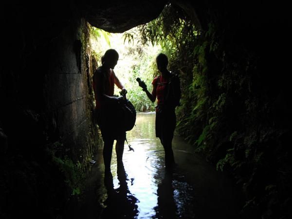 Sarah and Lea Davison get ready at the mouth of a tunnel in Kauai