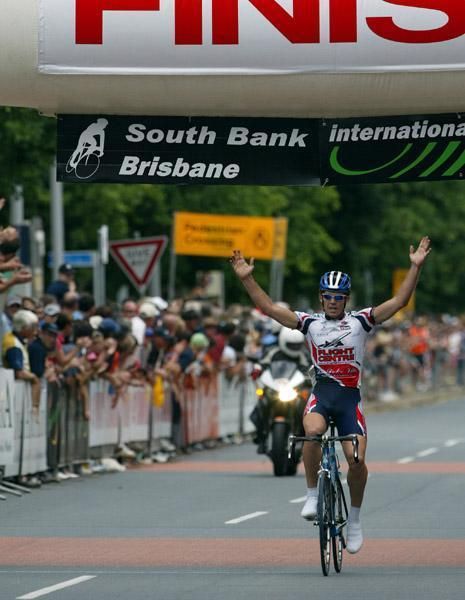 Local Flight Centre rider Mark Roland raises his arms in victory as winner of the elite men's race