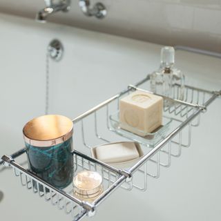 A bath tray with soap and candle