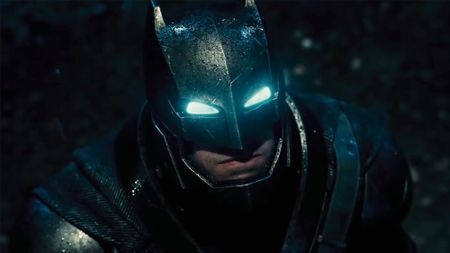 Scene with Batman's eyes lit up in the dark night in Batman v Superman. Batman has metal gear on.