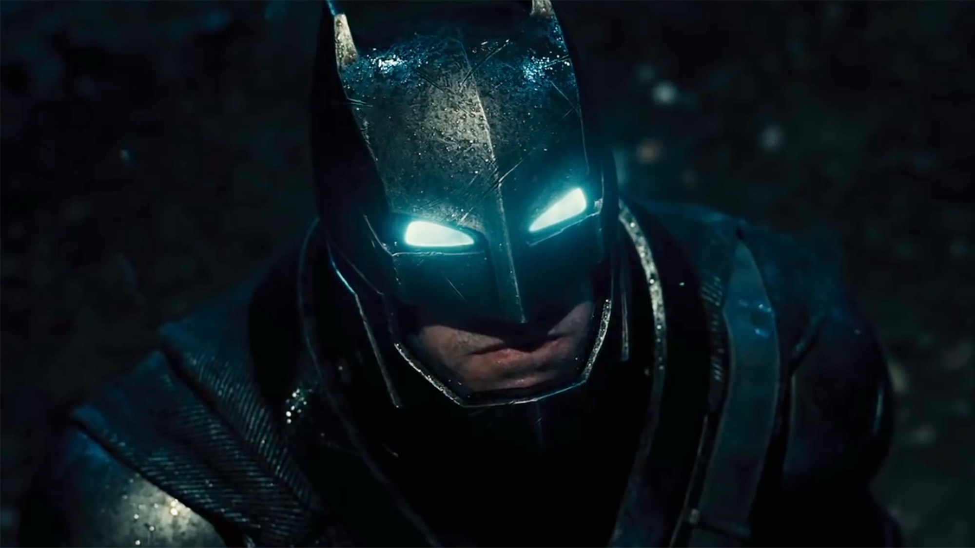 Scene with Batman's eyes lit up in the dark night in Batman v Superman. Batman has metal gear on.