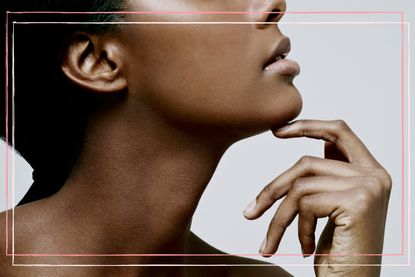 a black woman holding her hand to her chin in a close up shot