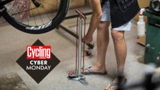 Cyclist using the Silca Super Pista Ultimate Hiro Edition Floor Pump, and the Cycling Weekly Cyber Monday deals roundel
