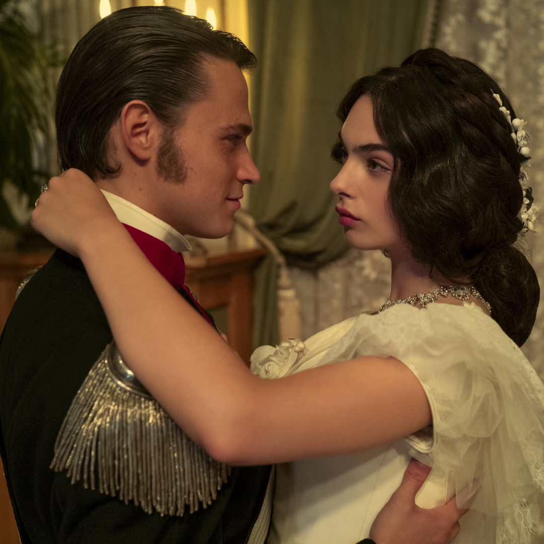 a man in a period war uniform and a woman in a white gown dance together in a still from the leopard