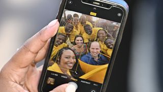 Locals take a selfie with Catherine, Duchess of Cambridge and Prince William, Duke of Cambridge in Trench Town