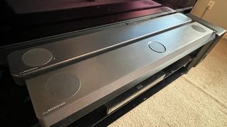 LG S80QY soundbar on TV stand as seen from above