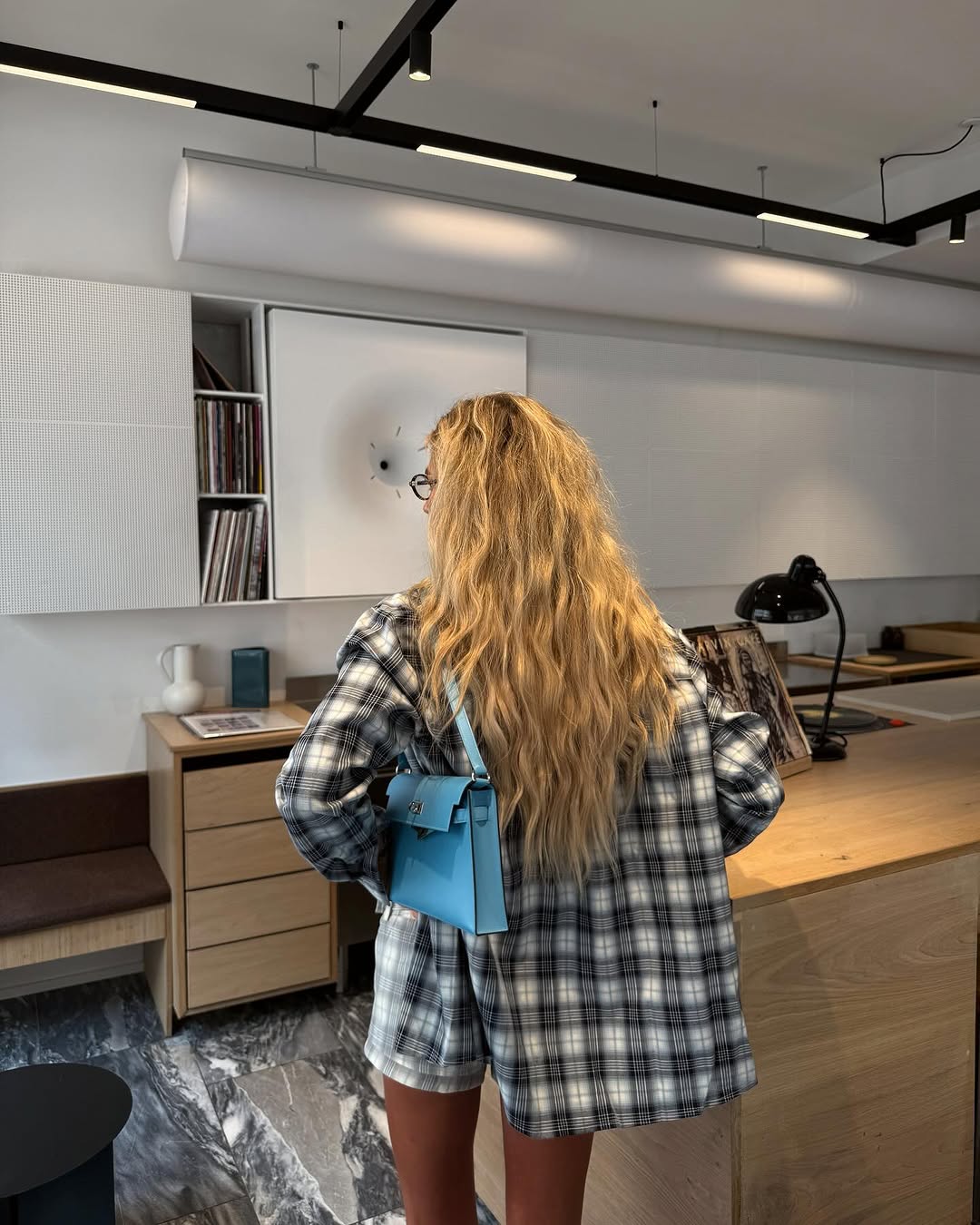 Woman wearing plaid jacket trend fall 2025.