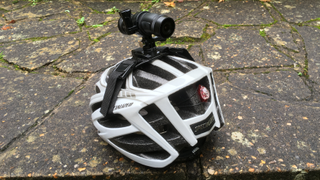 Image shows the Techalogic DC-1 mounted on a bike helmet