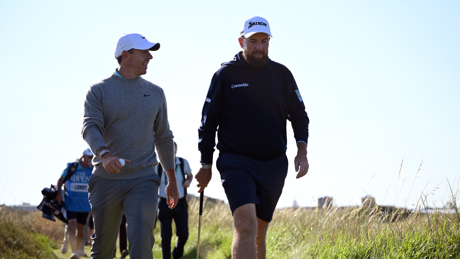 Rory McIlroy and Shane Lowry walk to the next tee box