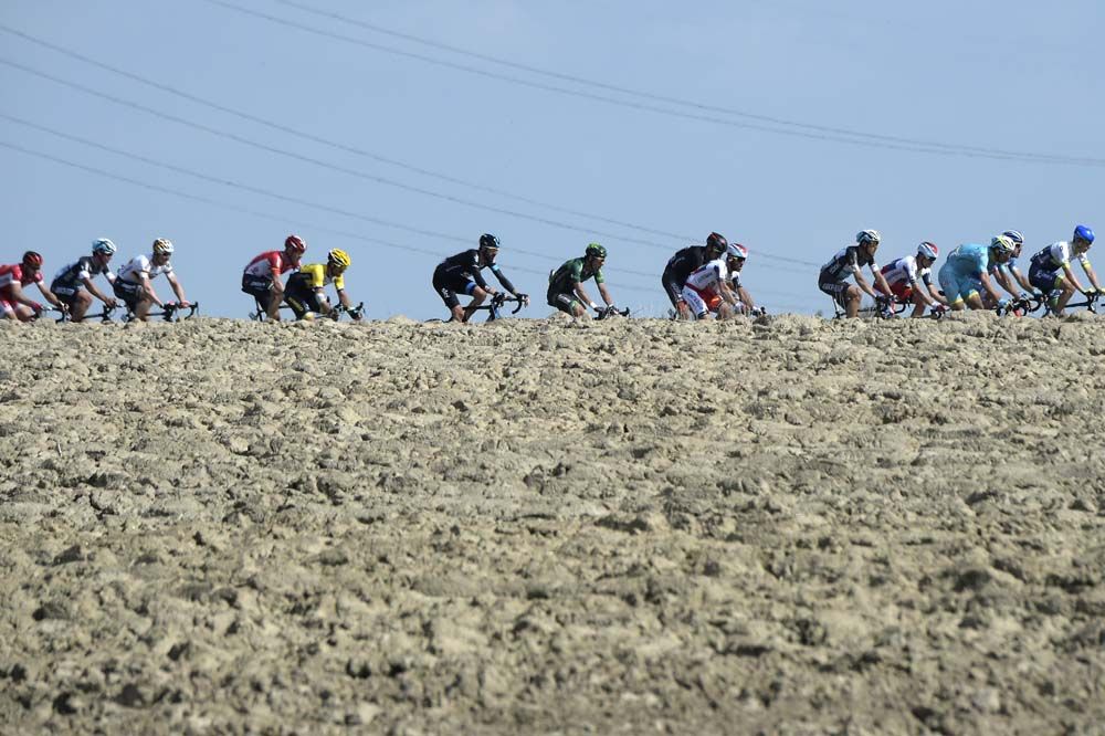 The riders race across the fields of northern France