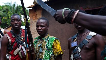Anti-Balaka fighters show their weapons outside Bangui 