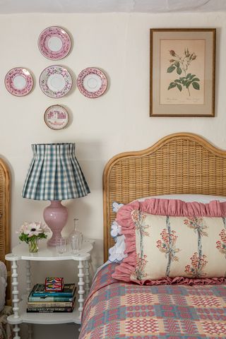 Pink bedroom with plates as decor