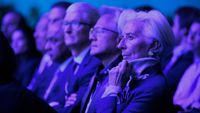 Tim Cook, Jensen Huang, and Christine Lagarde listening to a speech by Donald Trump at the WEF.